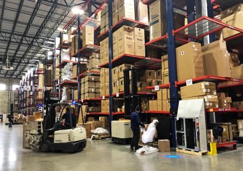 Warehouse workers deal with inventory stacked up to the ceiling at an ABT Electronics Facility in Glenview, Illinois, U.S. December 4, 2018. Picture taken December 4, 2018. To match Insight USA-RETAILERS/TRADE REUTERS/Richa Naidu