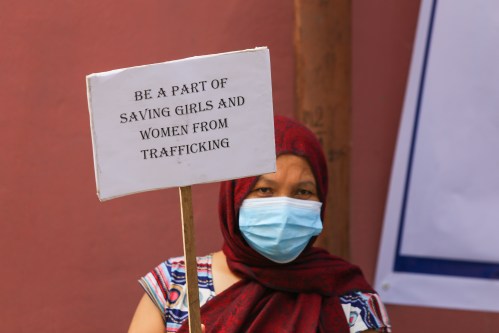 A sex worker holds a placard during a gathering to mark the "World Day Against Trafficking in Persons" organized by "Maiti Nepal", a non-profit organization in Nepal dedicated to help the victims of human trafficking and orphanage home for HIV-affected children and women. The "World Day Against Trafficking in Persons" is celebrated worldwide on July 30th. (Photo by Sunil Pradhan / SOPA Images/Sipa USA)No Use Germany.