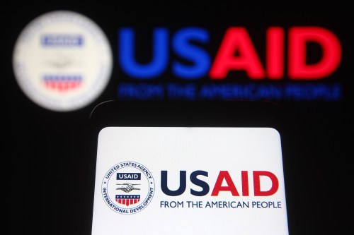 In this photo illustration, USAID (United States Agency for International Development) logo seen on a smartphone and a pc screen in the background. (Photo by Pavlo Gonchar / SOPA Images/Sipa USA)No Use Germany.