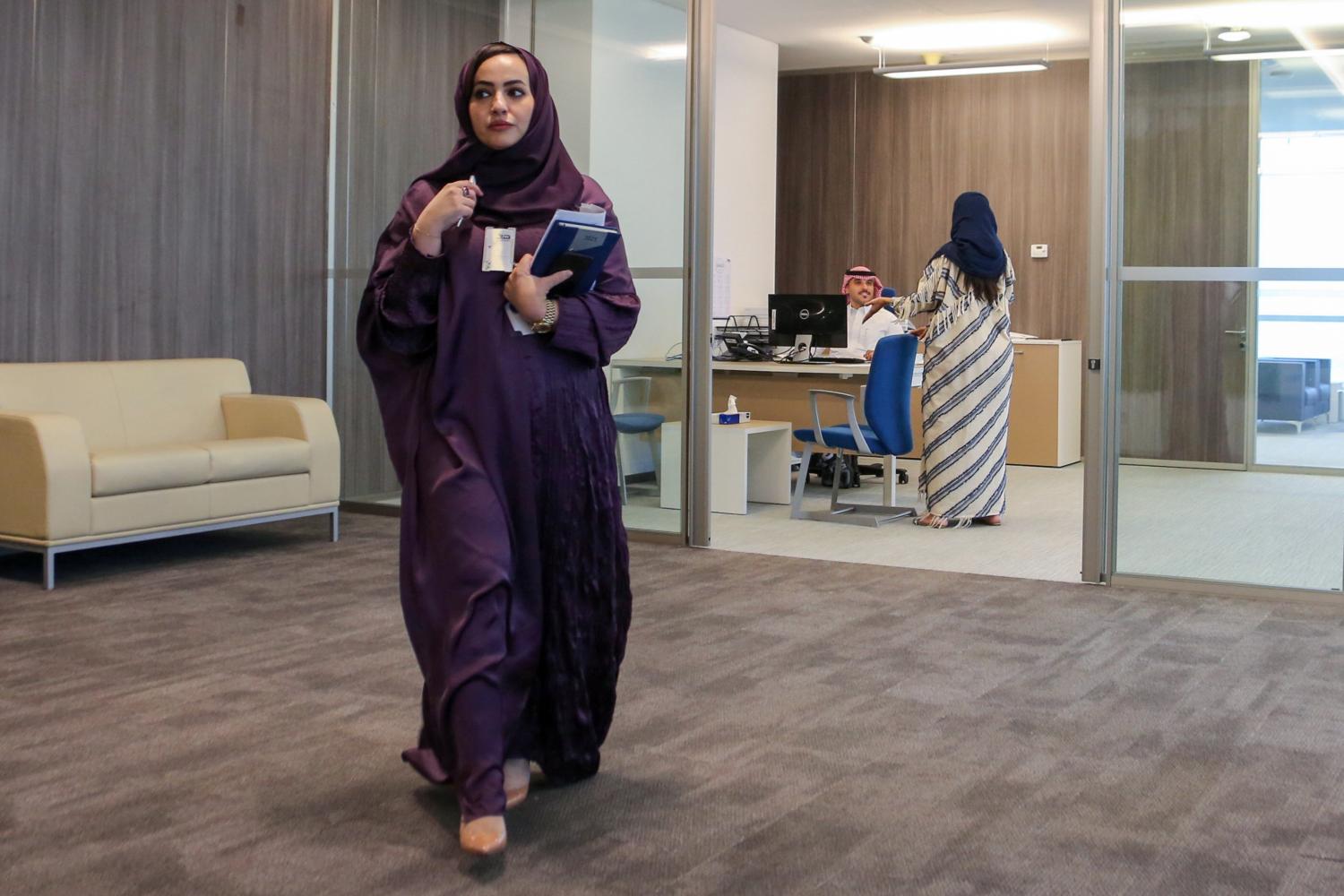 Nouf al-Qahtani, Enablement Programs Manager at Saudi Human Resources Development Fund, walks in the office in Riyadh, Saudi Arabia August 19, 2021. Picture taken August 19, 2021. REUTERS/Ahmed Yosri