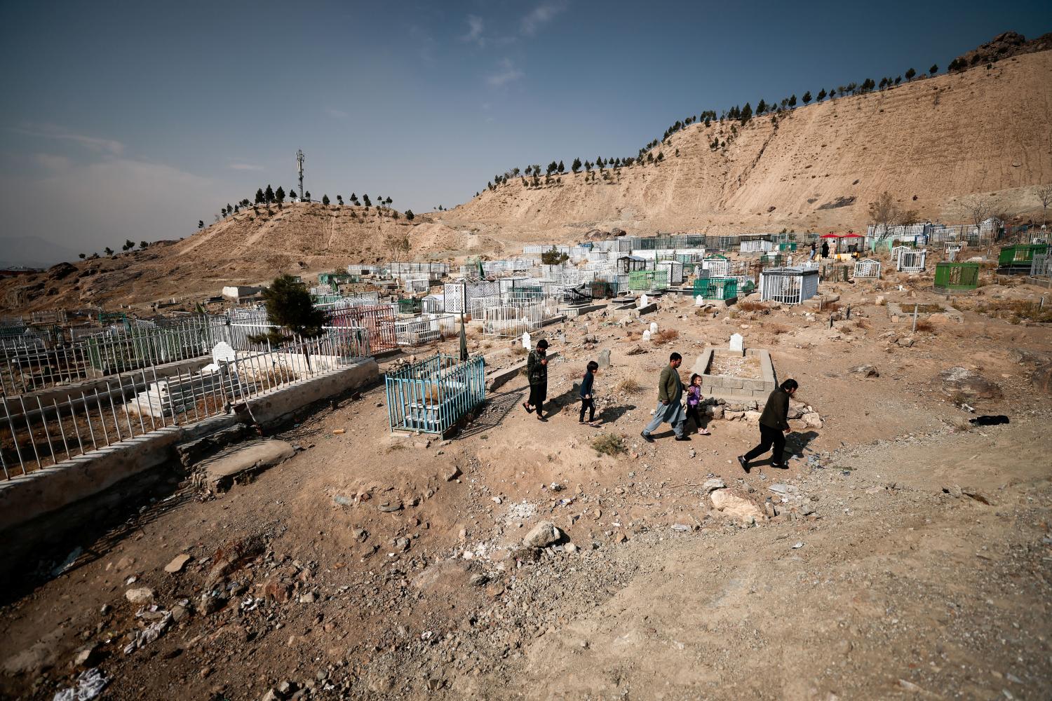 Emal Ahmadi, his brother Ajamal and their children leave the cemetery after praying by the graves of their family members who were victims of a U.S drone strike that killed 10 civilians, including seven children, in Kabul, Afghanistan November 7, 2021. Picture taken November 7, 2021. REUTERS/Zohra Bensemra