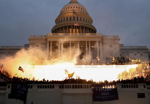 FILE PHOTO: An explosion caused by a police munition is seen while supporters of U.S. President Donald Trump riot in front of the U.S. Capitol Building in Washington, U.S., January 6, 2021. REUTERS/Leah Millis/File Photo