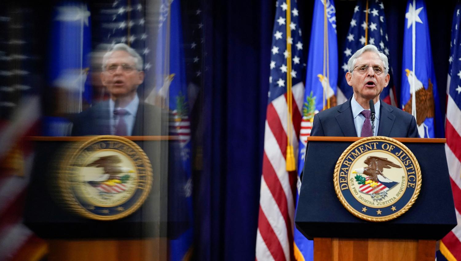 Attorney General Merrick Garland is reflected in a technician's monitor as he speaks at the Department of Justice in Washington, U.S., January 5, 2022