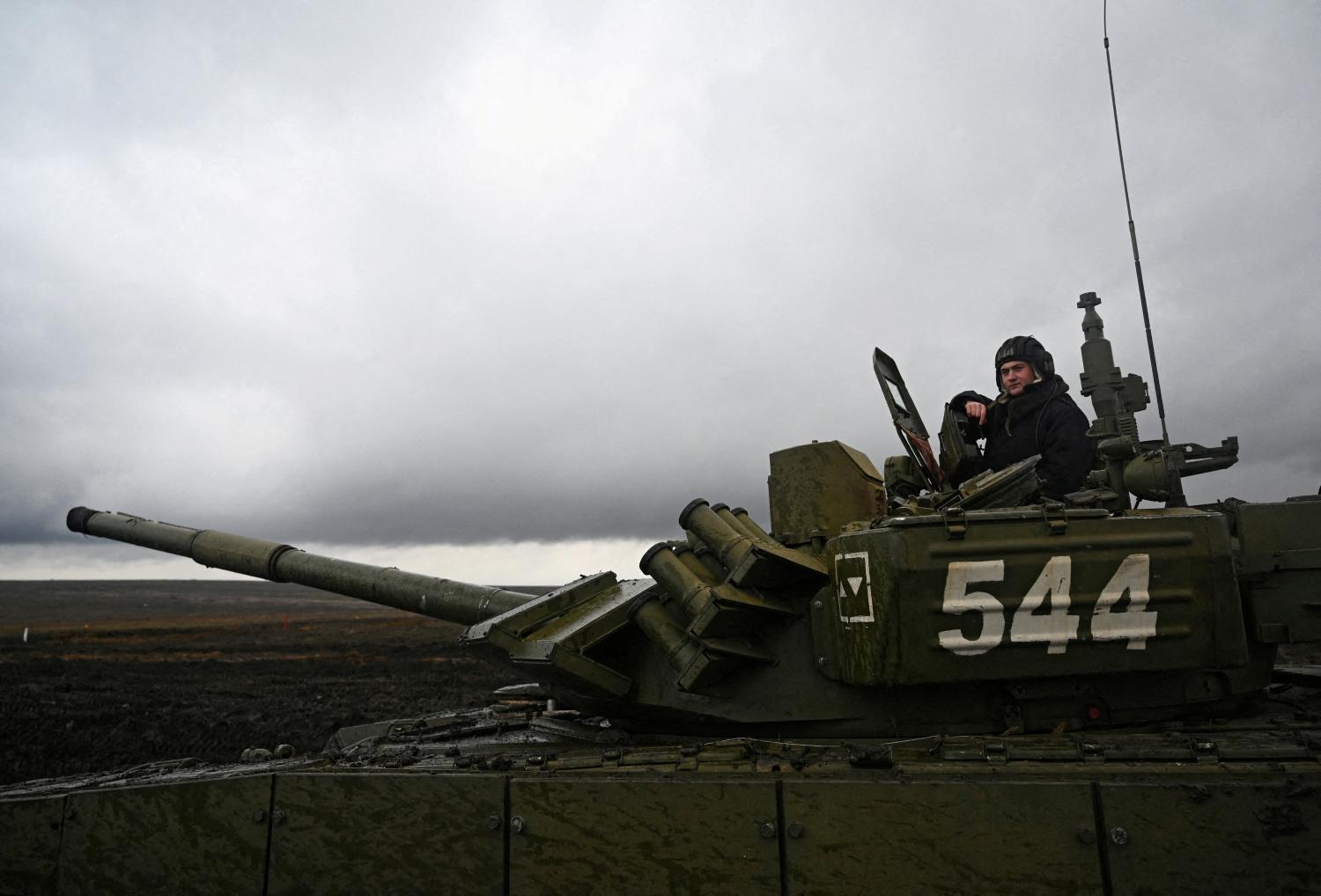 FILE PHOTO: A Russian service member is seen atop a T-72B3 main battle tank during military drills at the Kadamovsky range in the Rostov region, Russia December 20, 2021. REUTERS/Sergey Pivovarov/File Photo