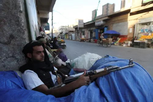 FILE PHOTO: A Shi'ite Houthi fighter sits behind sandbags near a checkpoint in Sanaa December 17, 2014. REUTERS/Mohamed al-Sayaghi/File Photo
