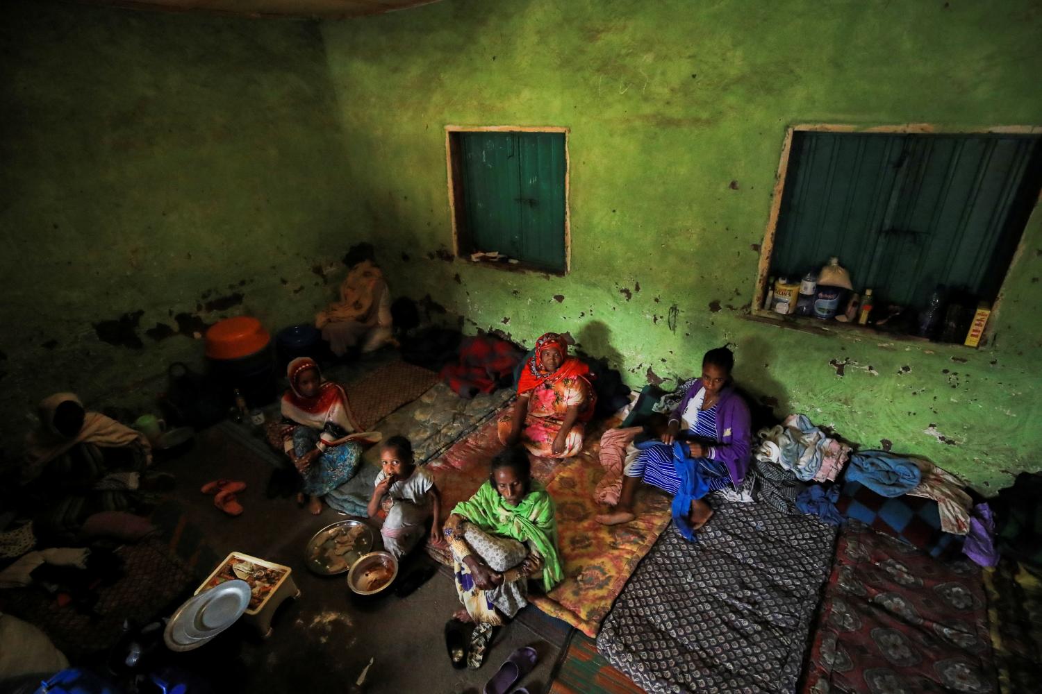 Women sit in their shelter at a camp for the internally displaced due to the fighting between the Ethiopian National Defense Force (ENDF) and the Tigray People's Liberation Front (TPLF) forces in Dessie town, Amhara region, Ethiopia, October 8, 2021. Picture taken October 8, 2021. REUTERS/Tiksa Negeri