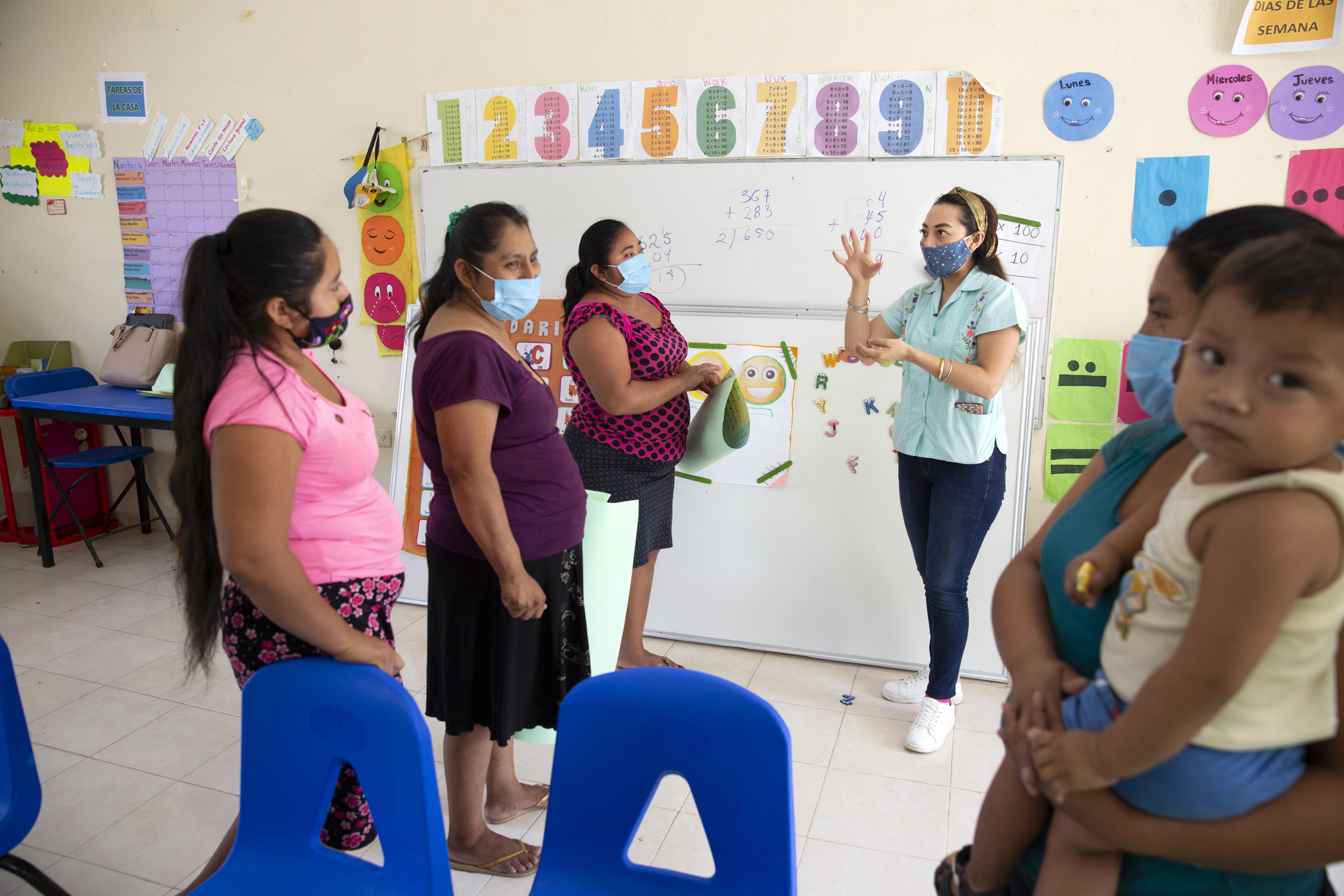 Mary Carmen Che Chi, 31, meets with the mothers of her pupils, amid the coronavirus pandemic at the Ignacio Ramírez Calzada primary school in the indigenous community of Celtún, Chichimilá municipality, Yucatán state, Mexico on May 4, 2021. Mary Carmen meets with the parents every two weeks to distribute learning materials, as well as to support and coach them through at-home learning during school closure. The Covid-19 pandemic has disrupted education for an estimated 90 percent of the worlds school children. In Mexico, schools have been closed since mid-March 2020 and the government switched the system to distanced learning or Aprende en Casa (Learn at Home), where students learn on television and the internet at home. However, due to the lack of internet connectivity and the barrier of the language, distance learning has been impossible for many children in isolated and impoverished parts of the country. Celtún is a rural, remote and indigenous community in the state of Yucatán, with no telecommunications infrastructure. There, to ensure continuity of learning to their students, teachers at the Ignacio Ramírez Calzada primary school Mary Carmen Che Chi and José Manuel Cen Kauil, prepare bilingual learning materials at their home and distribute it to their students every two weeks. Today, schools still remain closed in Mexico, but since September 2020, the two teachers have gotten the green light from their supervisor to run small in-person classes every two weeks at the school as the coronavirus pandemic continues. (Photo by Bénédicte Desrus/Sipa USA)No Use Germany.