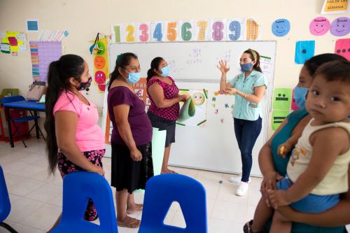 Mary Carmen Che Chi, 31, meets with the mothers of her pupils, amid the coronavirus pandemic at the Ignacio Ramírez Calzada primary school in the indigenous community of Celtún, Chichimilá municipality, Yucatán state, Mexico on May 4, 2021. Mary Carmen meets with the parents every two weeks to distribute learning materials, as well as to support and coach them through at-home learning during school closure. The Covid-19 pandemic has disrupted education for an estimated 90 percent of the worlds school children. In Mexico, schools have been closed since mid-March 2020 and the government switched the system to distanced learning or Aprende en Casa (Learn at Home), where students learn on television and the internet at home. However, due to the lack of internet connectivity and the barrier of the language, distance learning has been impossible for many children in isolated and impoverished parts of the country. Celtún is a rural, remote and indigenous community in the state of Yucatán, with no telecommunications infrastructure. There, to ensure continuity of learning to their students, teachers at the Ignacio Ramírez Calzada primary school Mary Carmen Che Chi and José Manuel Cen Kauil, prepare bilingual learning materials at their home and distribute it to their students every two weeks. Today, schools still remain closed in Mexico, but since September 2020, the two teachers have gotten the green light from their supervisor to run small in-person classes every two weeks at the school as the coronavirus pandemic continues. (Photo by Bénédicte Desrus/Sipa USA)No Use Germany.