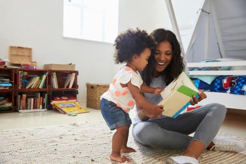 A mother reads to her toddler.