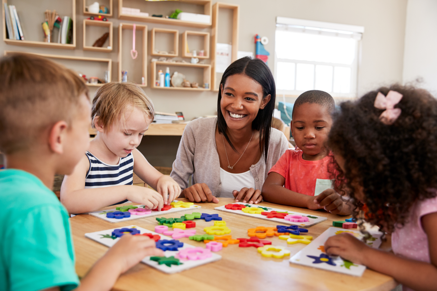 Teacher And Pupils Using Flower Shapes In preschool_small