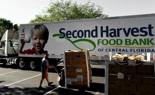 May 8, 2021 - Orlando, Florida, United States - A man unloads pallets of food assistance from the Second Harvest Food Bank of Central Florida at a mobile food distribution site on May 8, 2021 in Orlando, Florida. Although the coronavirus pandemic is beginning to ease and employers are hiring, families in Central Florida continue to experience food insecurity. (Photo by Paul Hennessy/NurPhoto)NO USE FRANCE