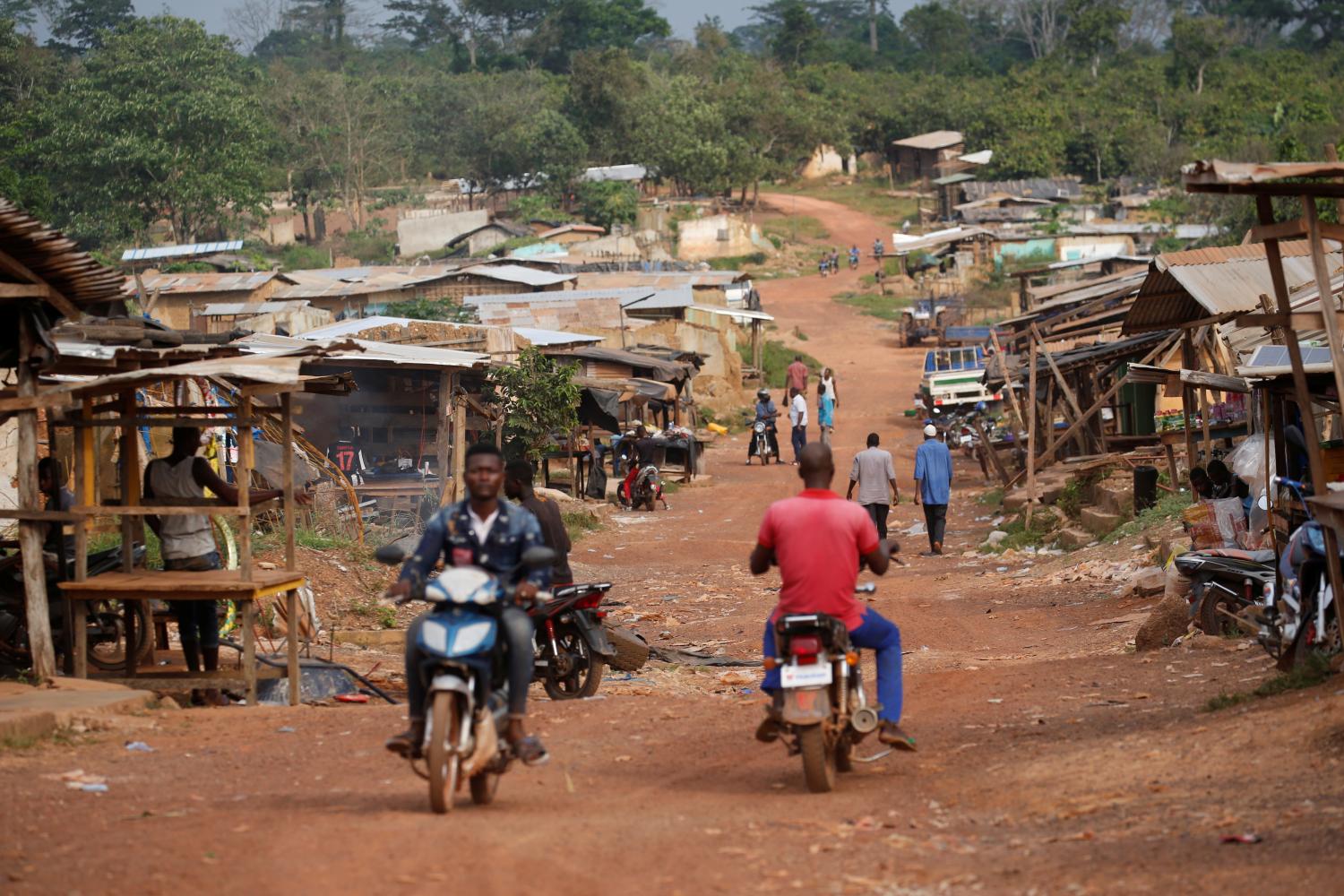 Residents are seen in the Ivorian cocoa farming village of Djigbadji, commonly known as Bandikro or Bandit Town, located inside the Rapides Grah protected forest and destroyed by forest authorities in January 2020, in Soubre, Ivory Coast January 7, 2021. Picture taken January 7, 2021. REUTERS/Luc Gnago