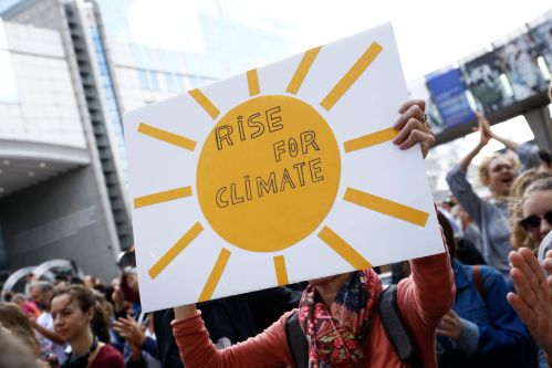 Brussels, Belgium. 8th Sep. 2018.Activists hold placards and chant slogans during a demonstration to demand immediate an action on climate change in front of European Parliament.