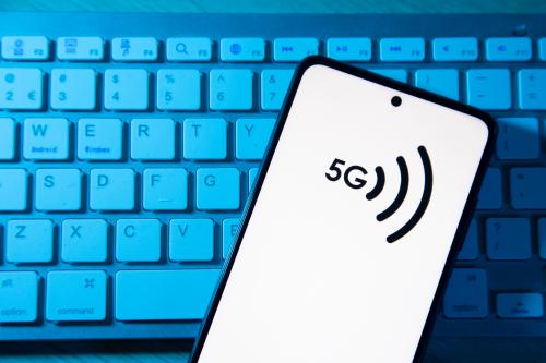 Photo illustration of a 5G signal symbol logo displayed on a smartphone display on top of a keyboard. Eindhoven, the Netherlands on January 27, 2022 (Photo Illustration by Nicolas Economou/NurPhoto)NO USE FRANCE