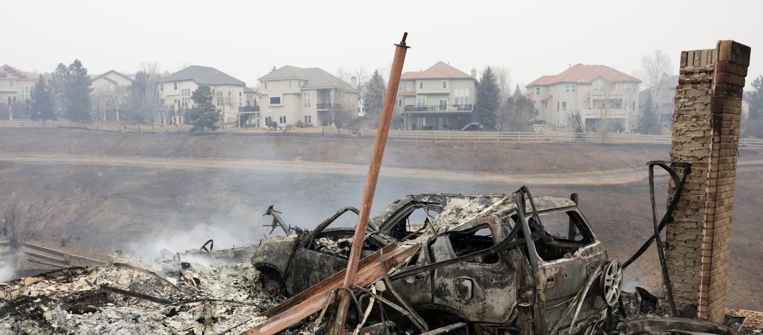 A view shows remains of a building and a car damaged by wildfires, a day after evacuation orders, in Superior, Colorado, U.S. December 31, 2021. REUTERS/Kevin Mohatt