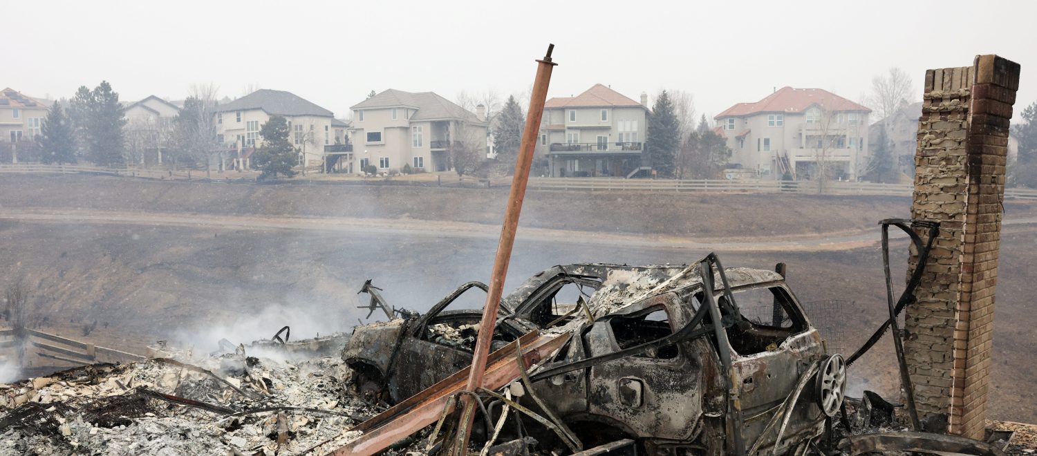 A view shows remains of a building and a car damaged by wildfires, a day after evacuation orders, in Superior, Colorado, U.S. December 31, 2021. REUTERS/Kevin Mohatt