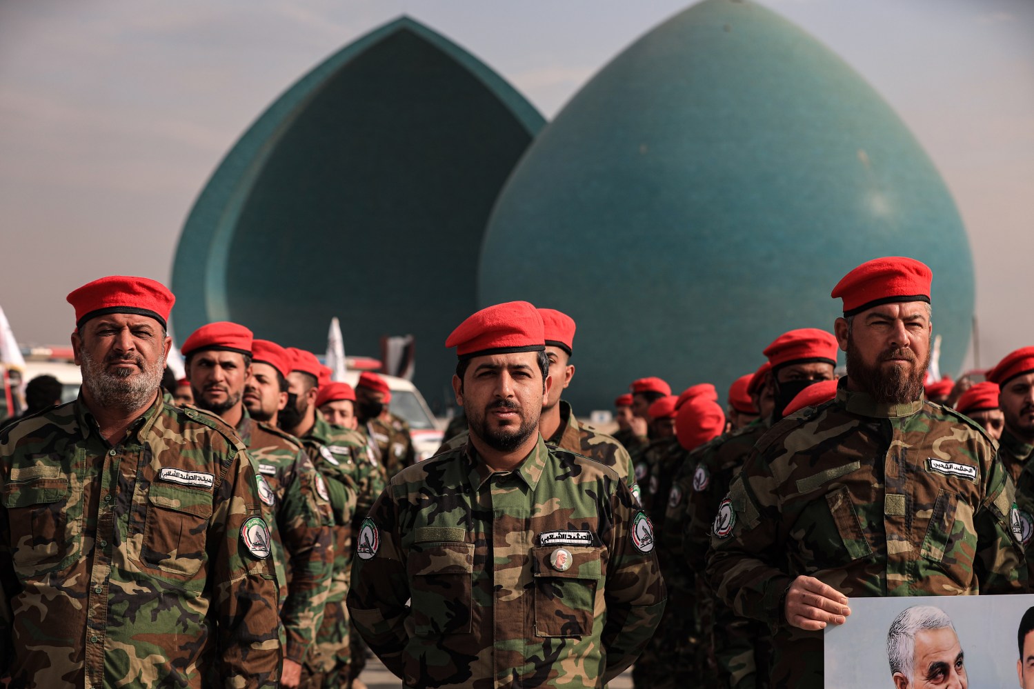 Members of the Iraqi predominantly Shia Muslim Popular Mobilization Forces (PMF) parade symbolic coffins at Baghdad's Tahrir Square during a rally organized to mark the second anniversary of the United States airstrikes that targeted weapons depots and command centres of the Iran-backed Hezbollah Brigades. The targeted paramilitary group, which constitutes part of the PMF, suffered dozens of casualties in the attacks that took place in Al-Qa'im, an Iraqi town located near the Syrian border. 12/29/2021, Ameer Al Mohammedaw/dpa