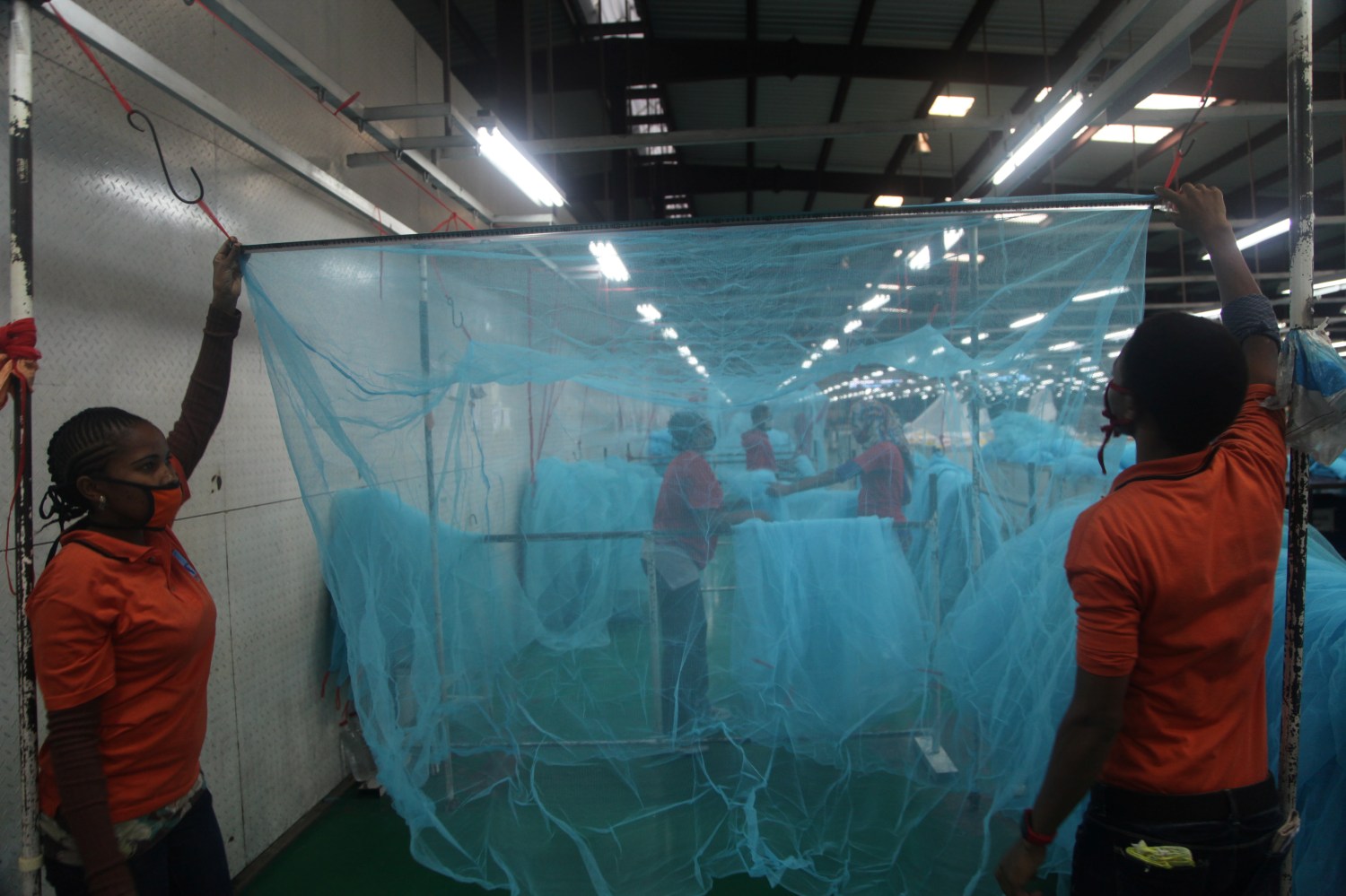 Workers look for abnormal holes in mosquito netting at the A to Z Textile Mills factory producing insecticide-treated bednets in Arusha, Tanzania, May 10, 2016. REUTERS/Katy Migiro