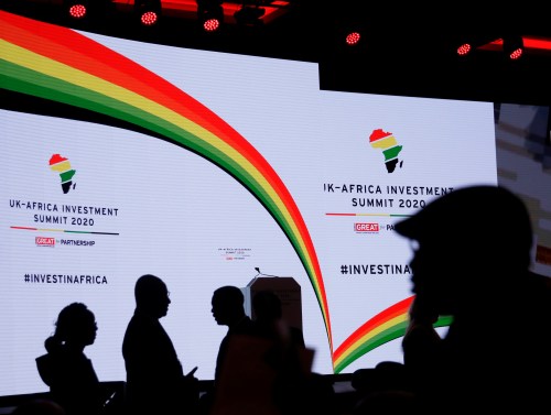 Delegates are silhouetted against the stage background at the UK-Africa Investment Summit in London, Britain January 20, 2020. Matt Dunham/Pool