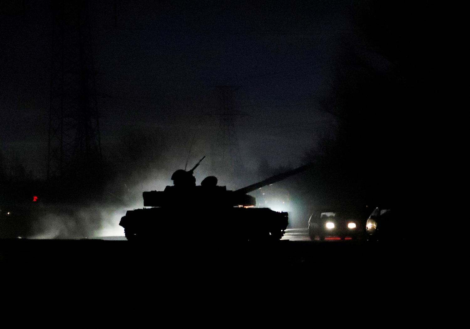 A tank drives along a street after Russian President Vladimir Putin ordered the deployment of Russian troops to two breakaway regions in eastern Ukraine following the recognition of their independence, in the separatist-controlled city of Donetsk, Ukraine February 22, 2022. REUTERS/Alexander Ermochenko     TPX IMAGES OF THE DAY