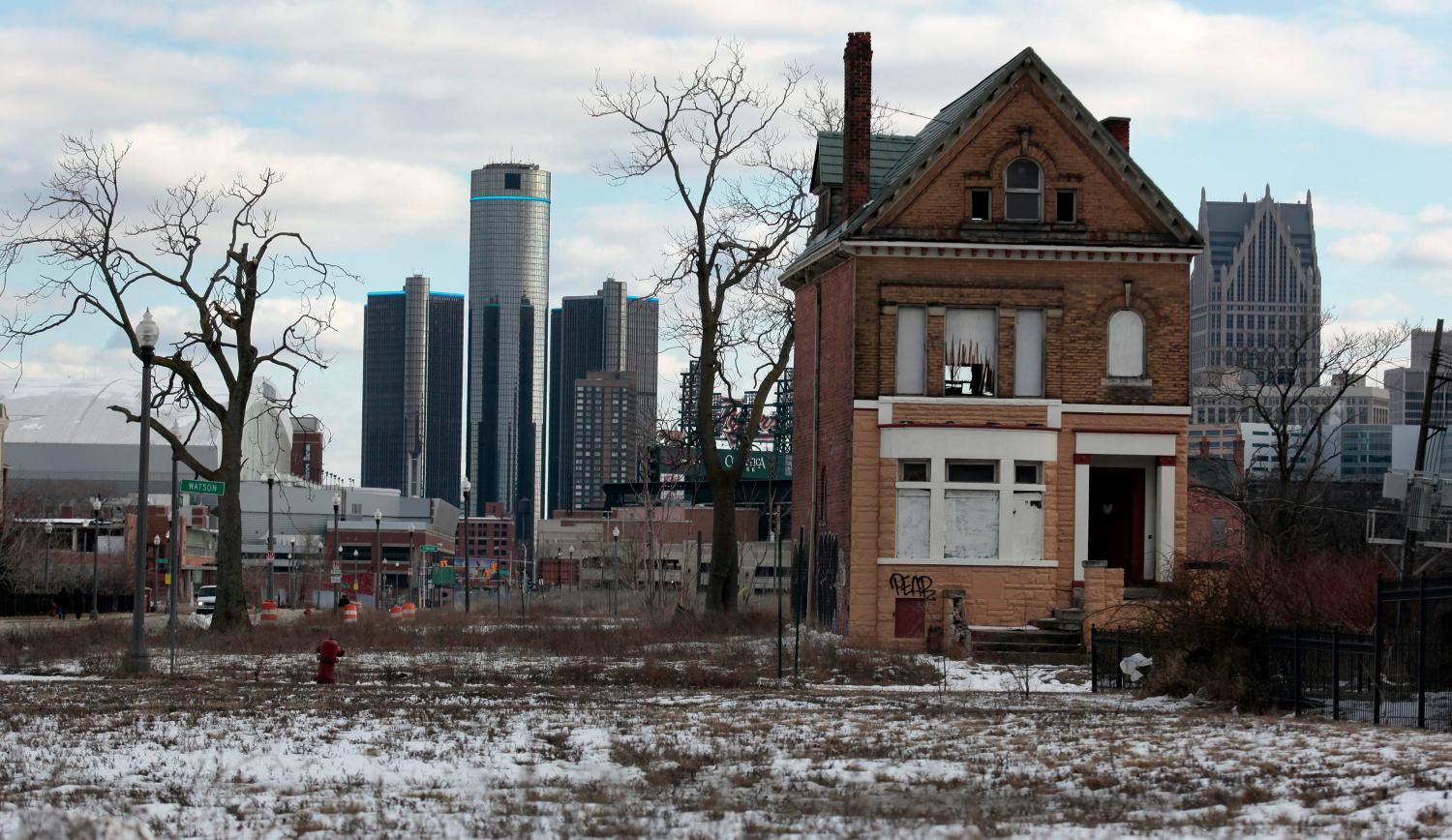 A vacant, boarded up house is seen in the once thriving Brush Park neighborhood with the downtown Detroit skyline behind it in Detroit, Michigan March 3, 2013. Michigan Governor Rick Snyder cleared the way for a state takeover of Detroit, declaring that the birthplace of the U.S. automotive industry faces a fiscal emergency and that he has identified a top candidate to assume its management. Friday's declaration by the Republican governor virtually assures that the state of Michigan will assume control of Detroit's books, and eventually decide whether the city should file the largest municipal bankruptcy in U.S. history.   REUTERS/ Rebecca Cook  (UNITED STATES - Tags: CITYSCAPE REAL ESTATE BUSINESS POLITICS)