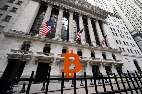 A Bitcoin currency emblem made by artist Leonid Sukala is placed along the security gate in front of the New York Stock Exchange
