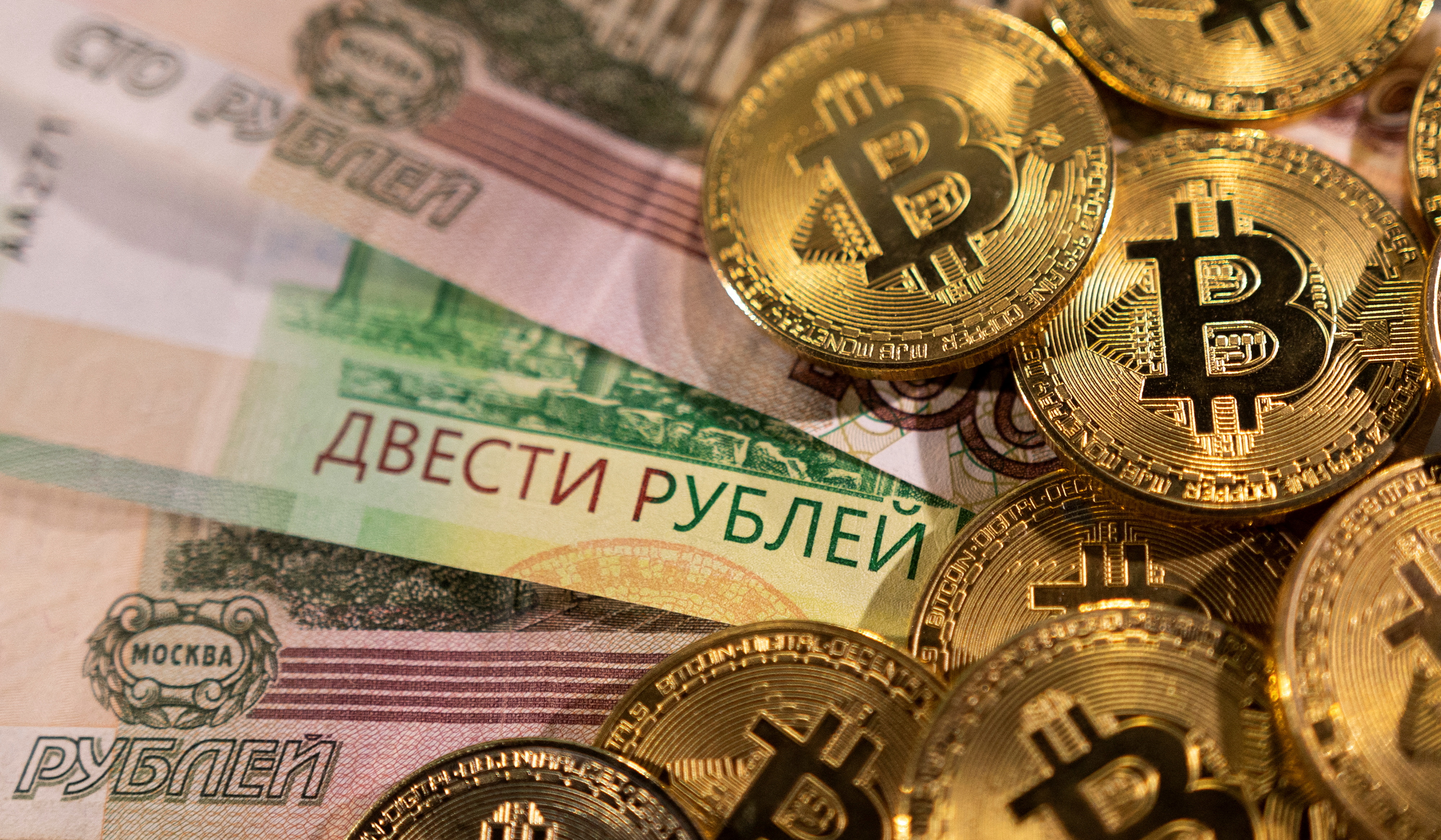 FILE PHOTO: Russian rouble banknotes and representations of the cryptocurrency Bitcoin are seen in this illustration taken March 1, 2022. REUTERS/Dado Ruvic/Illustration/File Photo
