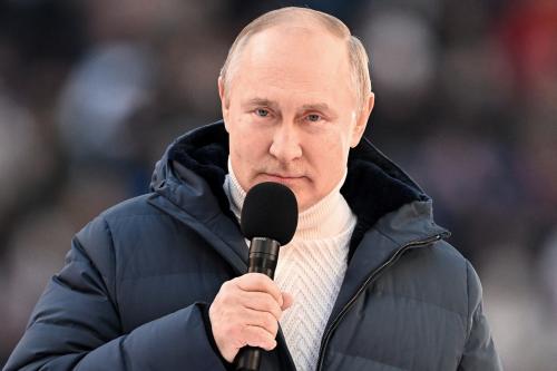Russian President Vladimir Putin delivers a speech during a concert marking the eighth anniversary of Russia's annexation of Crimea