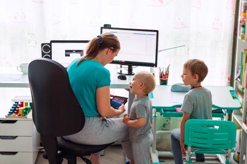 Mother working with two children.