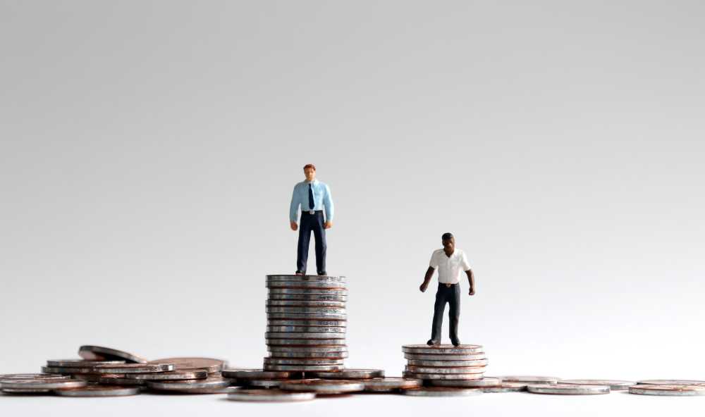 Toy figures standing on stacks of coins.