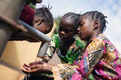 Adolescents in Africa wash their hands.
