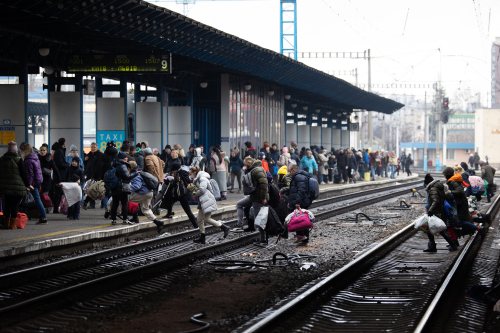 People cross the railways as they try to catch an evacuation train at Kyiv central train station, Ukraine, on March 2, 2022. On the seventh day of Russia invading Ukraine. Photo by Raphael Lafargue/ABACAPRESS.COM