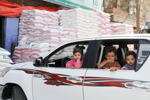 Children sit in a vehicle parked outside a wholesale food shop in Sanaa, Yemen February 28, 2022. Picture taken February 28, 2022. REUTERS/Khaled Abdullah