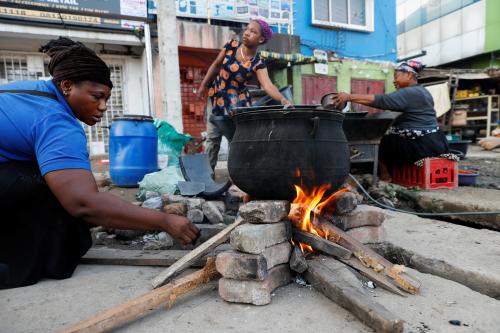 A woman cooks food in a pot on an improvised firewood cook stove at Computer Village neighborhood in Ikeja, Lagos, Nigeria November 3, 2021. Picture taken November 3, 2021. REUTERS/Temilade Adelaja