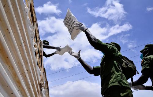 Members of Local Defence Unit (LDU) offload relief food during a distribution exercise to civilians affected by the lockdown, as part of measures to prevent the potential spread of coronavirus disease (COVID-19), in Kampala, Uganda April 4, 2020. REUTERS/Abubaker Lubowa