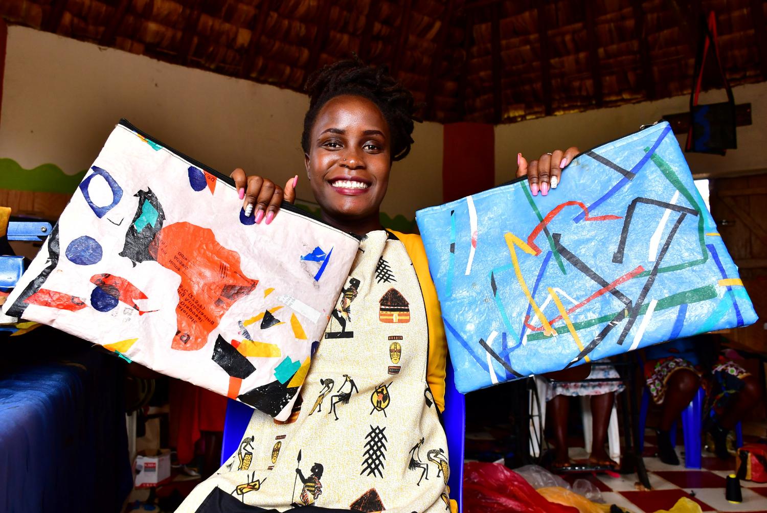 Ugandan self-proclaimed "waste-preneur" Faith Aweko displays finished hand bags made from transformed polythene waste at the Reform Africa in Social Innovation Academy (SINA), in Mpigi district, Central Uganda April 20, 2021. Picture taken April 20, 2021. REUTERS/Abubaker Lubowa