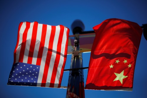 The flags of the United States and China fly from a lamppost in the Chinatown neighborhood of Boston, Massachusetts, U.S., November 1, 2021.   REUTERS/Brian Snyder