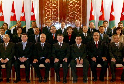 Jordan's King Abdullah joins new Prime Minister Badran and ministers for family photo after they swore the oath at Royal Palace in Amman.  Jordan's King Abdullah (C) joins new Prime Minister Adnan Badran (3rd L) and ministers for a family photo after they swore the oath at the Royal Palace in Amman April 7, 2005. A new Jordanian cabinet composed of economic reformers close to King Abdullah took office on Thursday, charged by the monarch with speeding up liberal reforms in response to outside pressure for change. REUTERS/Yousef Allan