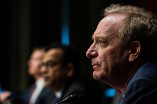 Microsoft President Brad Smith listens