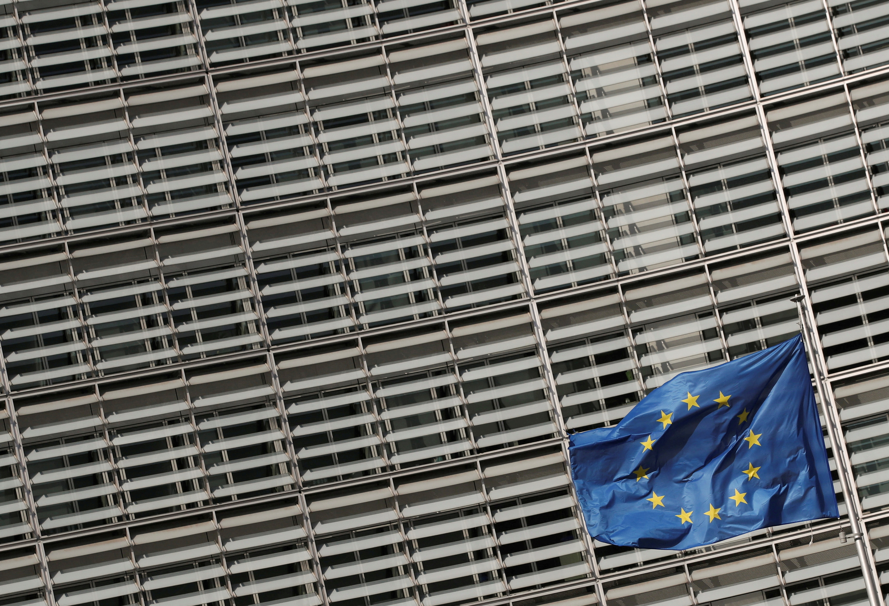 FILE PHOTO: A European Union flag flutters outside the European Commission headquarters in Brussels, Belgium, March 24, 2021. REUTERS/Yves Herman/File Photo