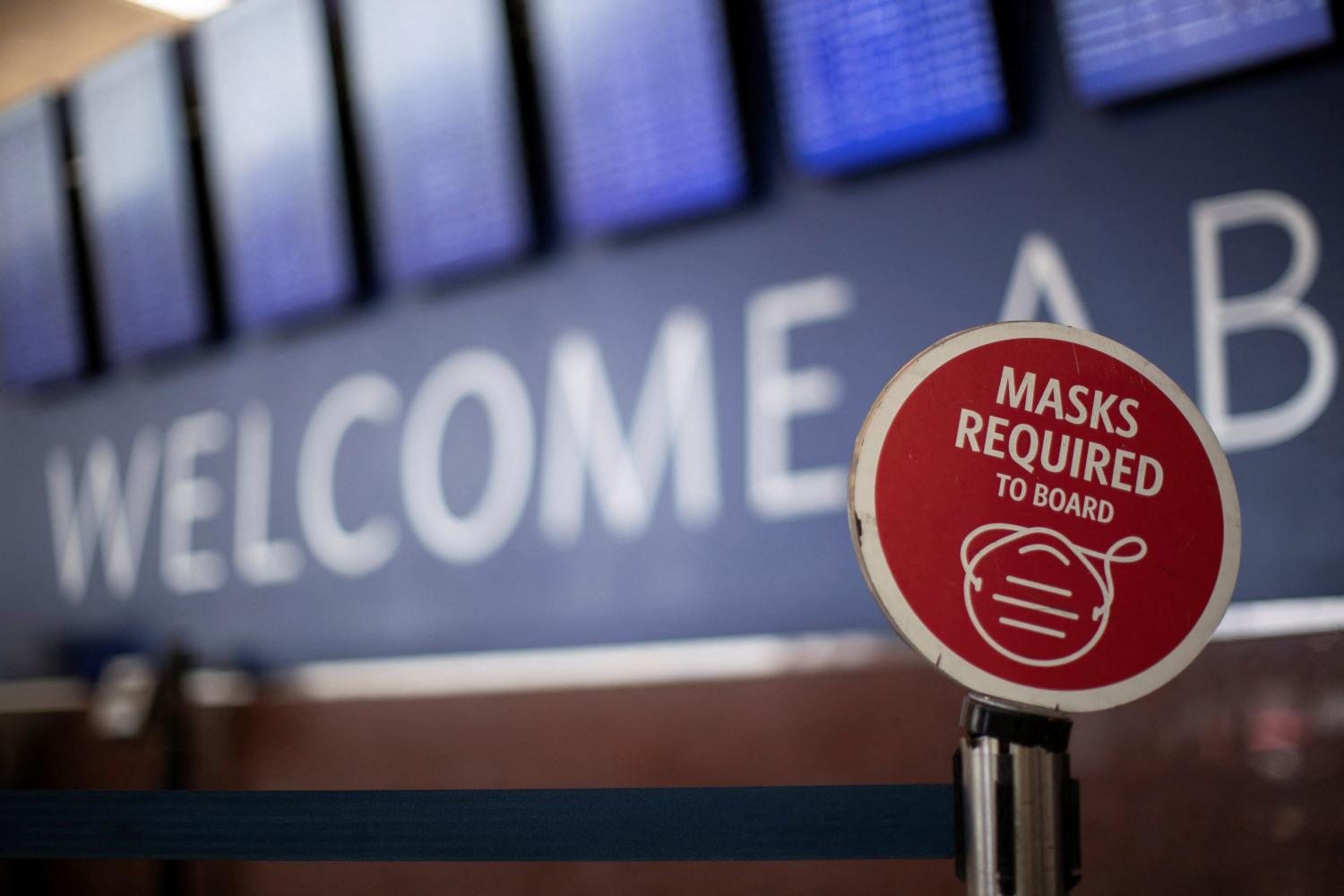An outdated sign requiring Delta Air Lines passengers to wear a face mask to board a plane is displayed in the domestic terminal of the Hartsfield-Jackson Atlanta International Airport after Biden's administration announced that it will no longer enforce a U.S. mask mandate on public transportation, following a Florida court ruling, in Atlanta, Georgia, U.S., April 19, 2022.  REUTERS/Alyssa Pointer