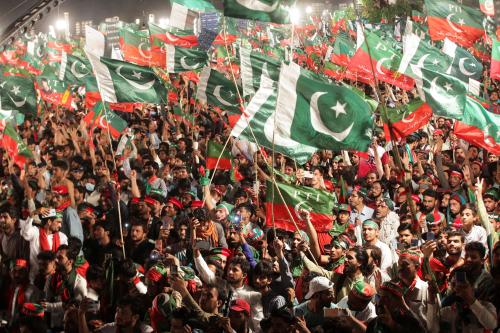 Supporters of the Pakistan Tehreek-e-Insaf (PTI) political party wave flags as they gather to listen to the speech of the ousted Pakistani Prime Minister Imran Khan during a rally, in Lahore, Pakistan April 21, 2022. REUTERS/Mohsin Raza
