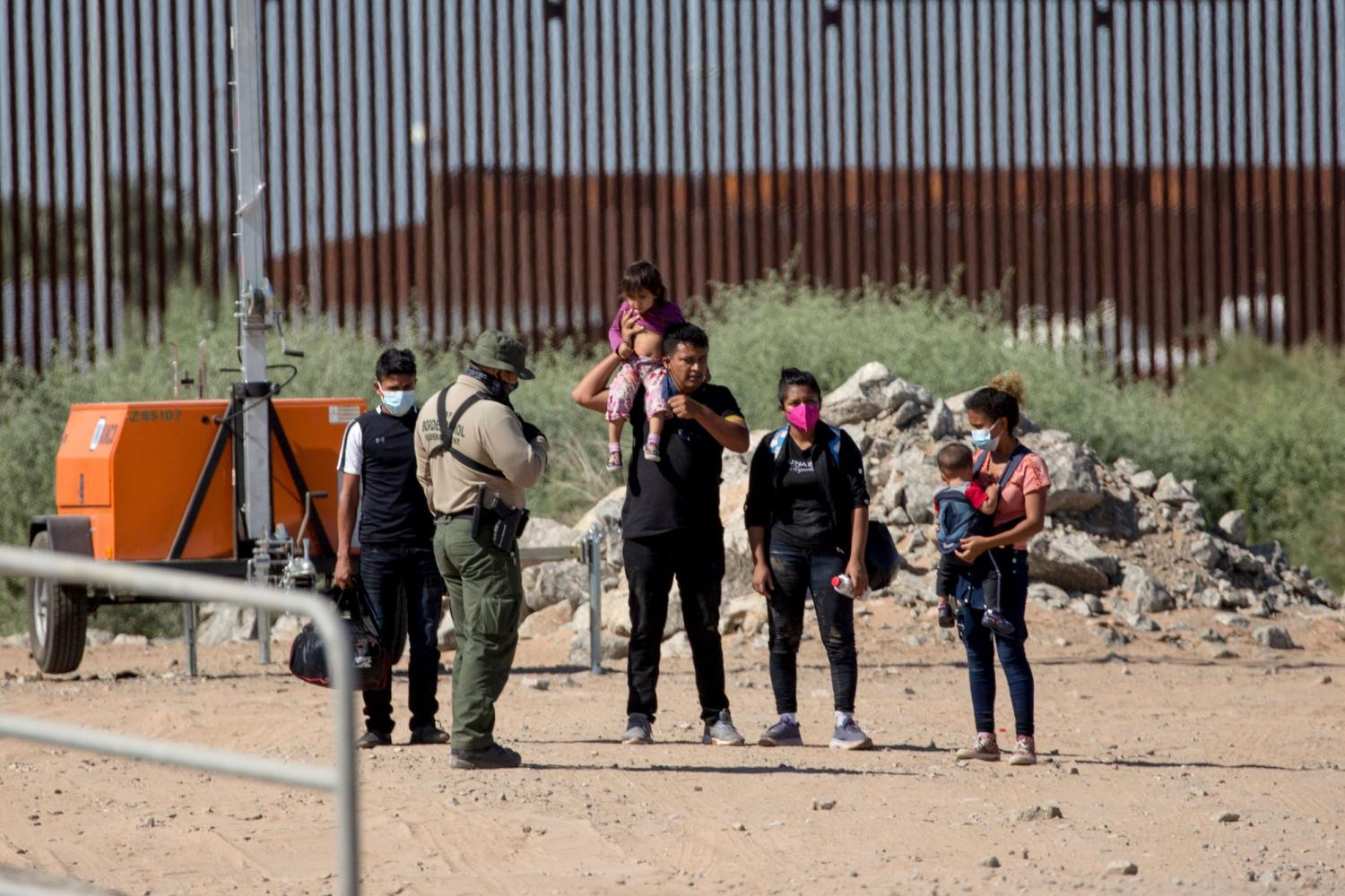 Guatemalan refugees talk to U.S. border patrol.