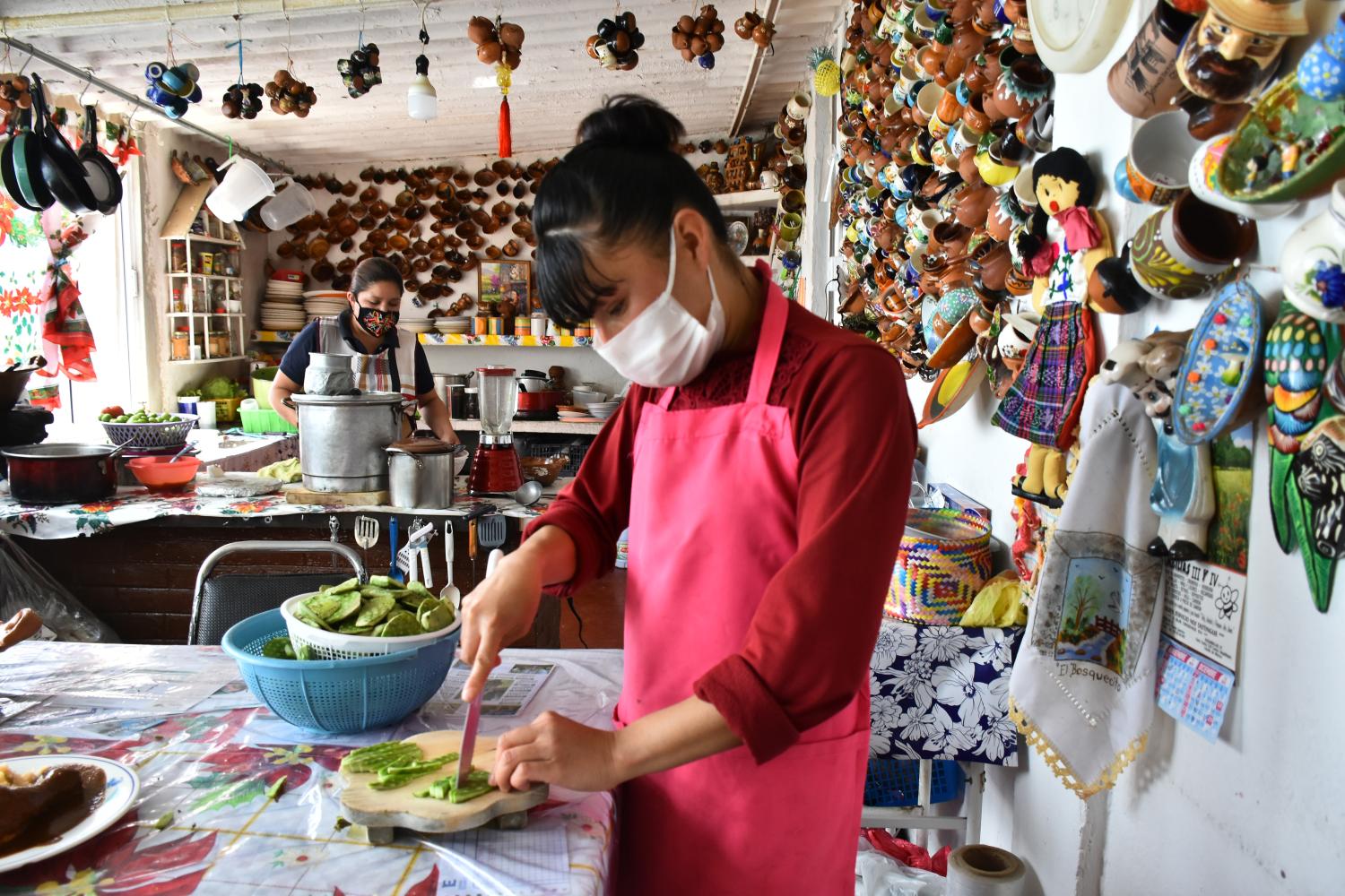 STATE OF MEXICO, MEXICO - MARCH 8: A woman who works in a restaurant in the town of Nopaltepec, State of Mexico, wears a face mask to prevent covid spread, while preparing food for tourists who visit the place on March 8, 2021 in State of Mexico, Mexico (Photo by Eyepix/Sipa USA)No Use Germany.