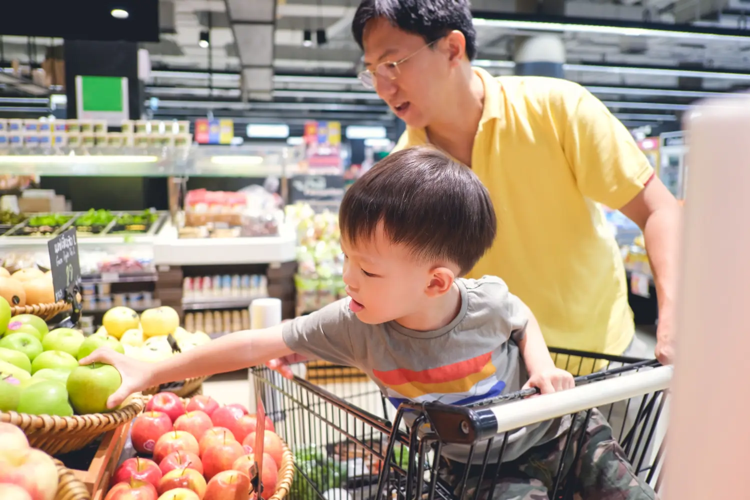 Father and son shopping in supermarket.