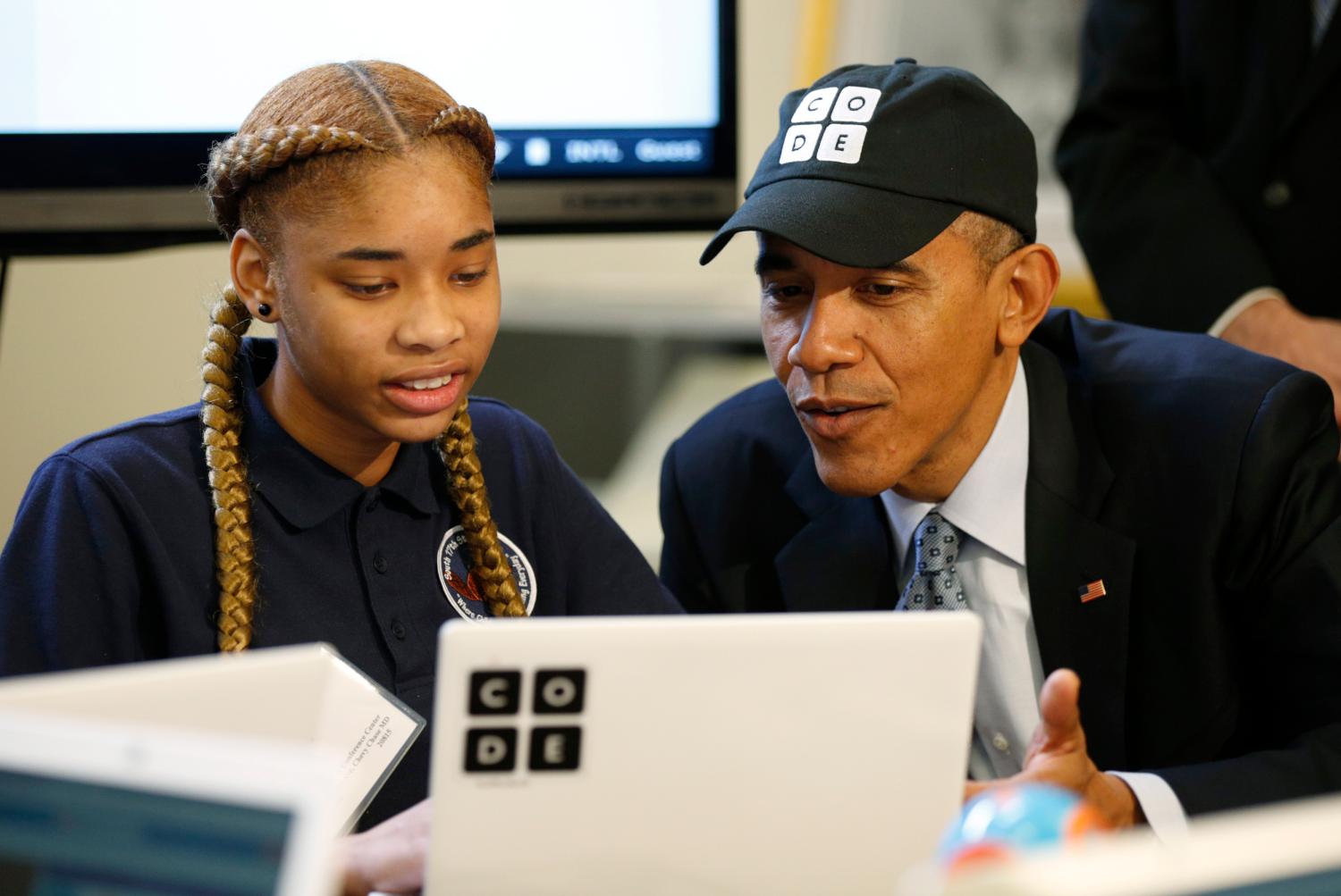 U.S. President Barack Obama talks with Adrianna Mitchell a student from Newark, New Jersey, taking part in an "Hour of Code"? event at the White House in Washington December 8, 2014.