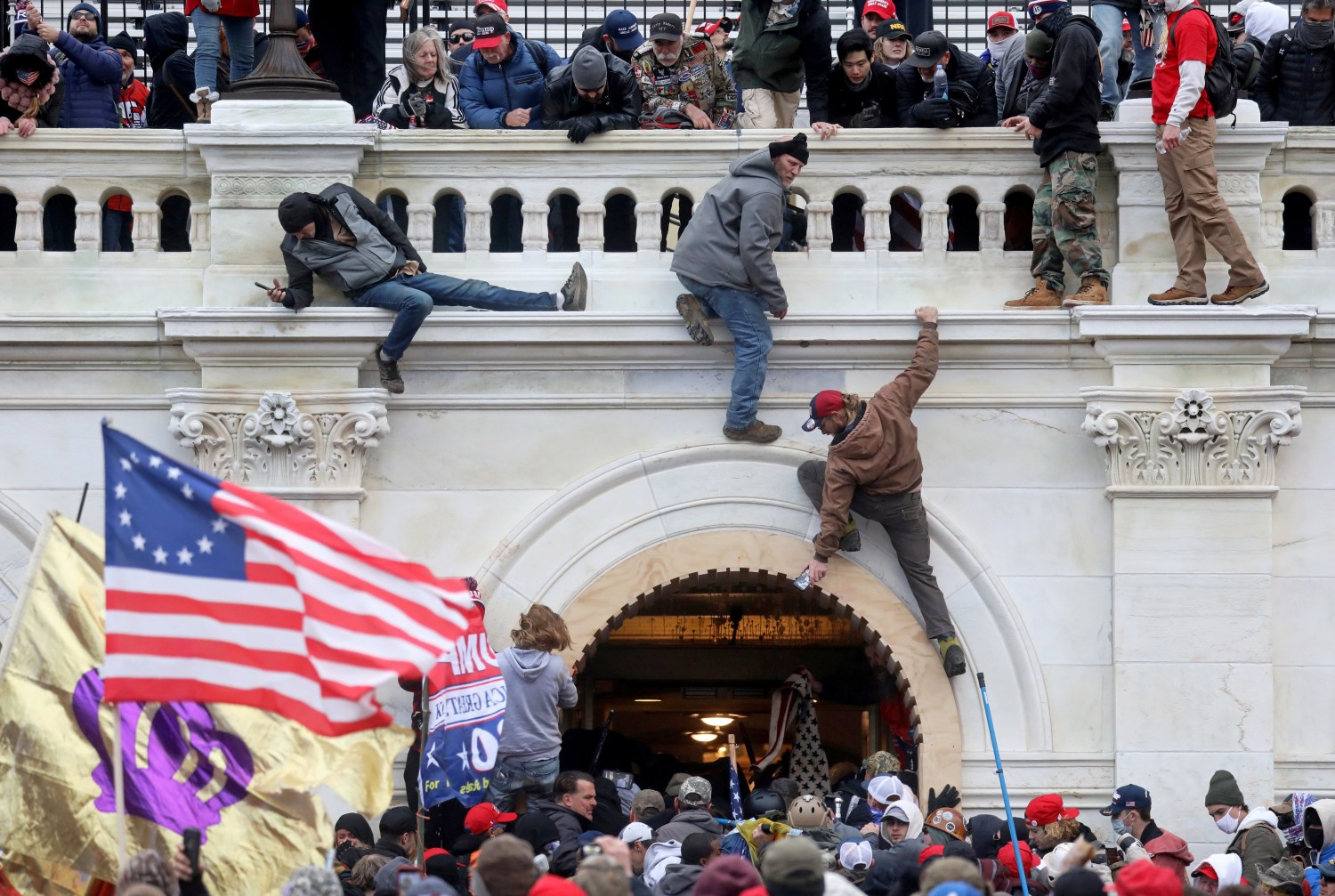 FILE PHOTO: A mob of supporters of U.S. President Donald Trump fight with members of law enforcement at a door they broke open as they storm the U.S. Capitol Building in Washington, U.S., January 6, 2021. REUTERS/Leah Millis/File Photo