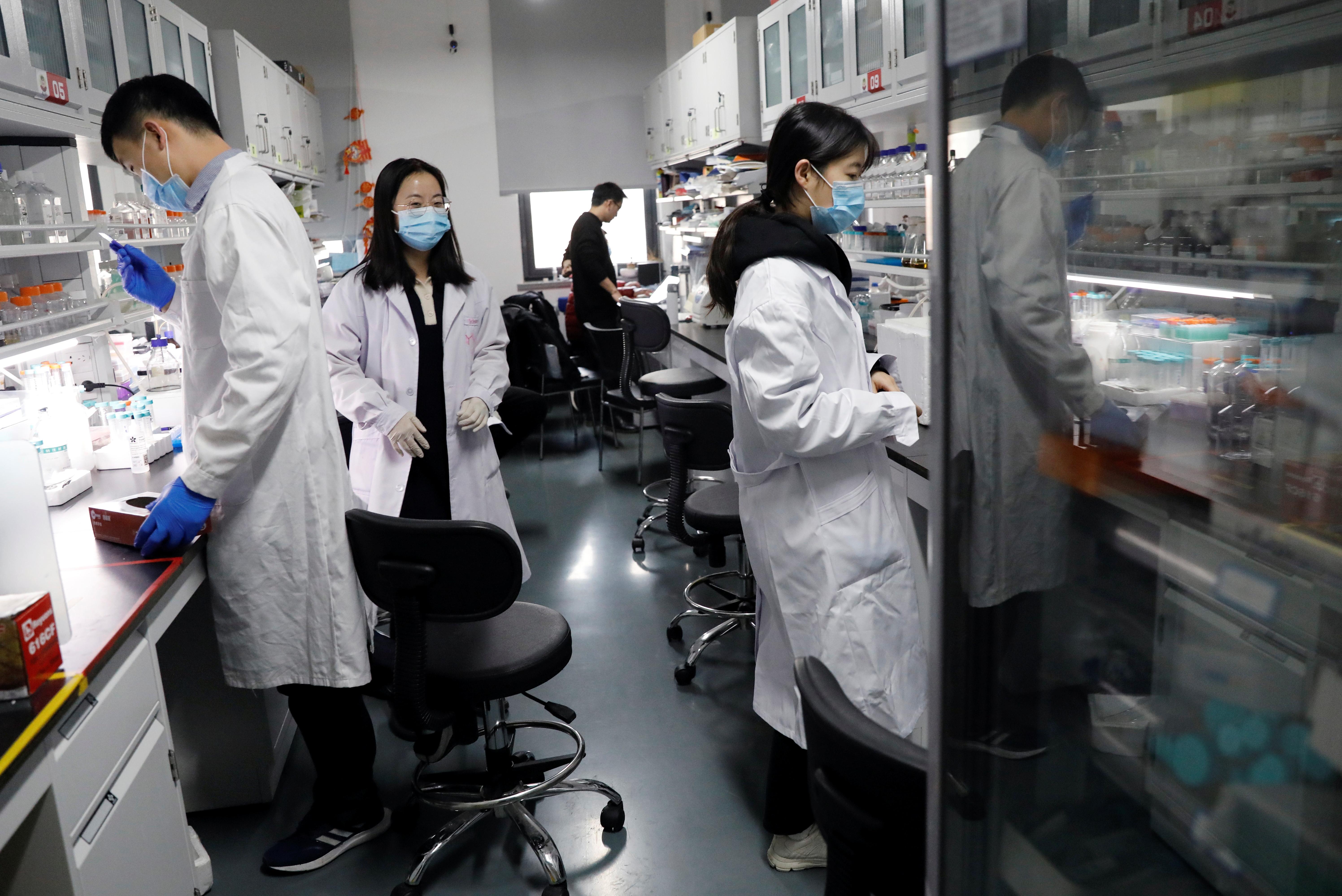 Researchers work in the Aging and Regeneration lab at the Institute for Stem Cell and Regeneration of the Chinese Academy of Sciences (CAS) in Beijing, China, January 12, 2021. Picture taken January 12, 2021. REUTERS/Tingshu Wang