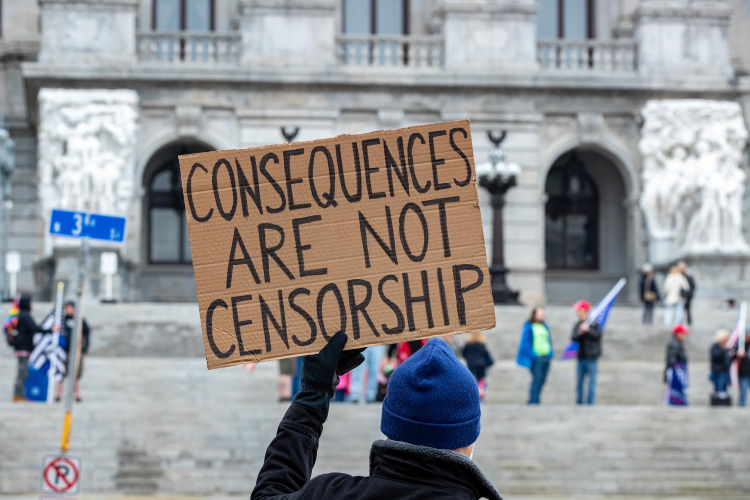 A protester holds a placard expressing his opinion across the street from the Pennsylvania State Capitol.About 40 people gathered on the steps of the Pennsylvania State Capitol for the '1st Amendment--Conservatives Being Censored' rally. (Photo by Paul Weaver / SOPA Images/Sipa USA)No Use Germany.