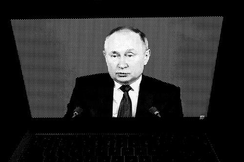 Russian President Vladimir Putin delivers his annual press conference on Dec. 23, 2021, as seen via a laptop screen.